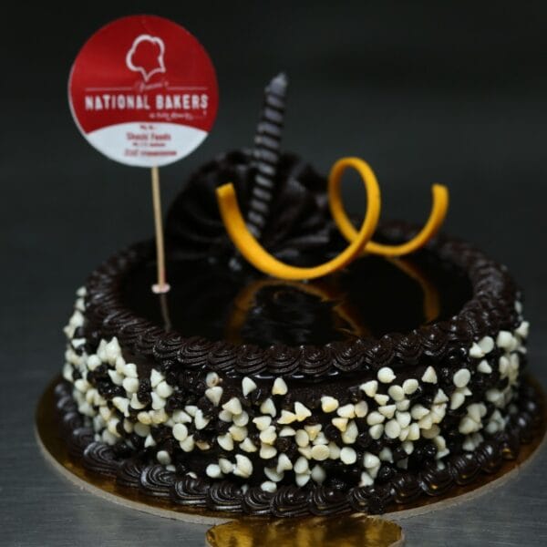 Black & White Choco Cake with layers of dark and white chocolate, decorated with chocolate swirls and shavings, perfect for celebrations.