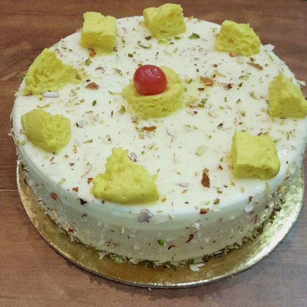 Freshly baked Rasmalai Cake by Pammi’s Bakers – soft sponge layered with creamy rasmalai flavors and garnished with nuts.
